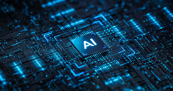 Nahaufnahme eines Computerchips mit der Aufschrift AI, umgeben von leuchtenden blauen Leiterbahnen.