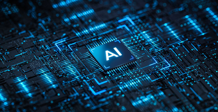 Nahaufnahme eines Computerchips mit der Aufschrift AI, umgeben von leuchtenden blauen Leiterbahnen.