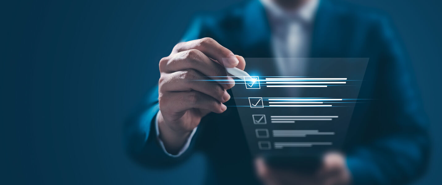 A businessperson in a suit interacts with a glowing, translucent, holographic checklist on a touchscreen, tapping a highlighted checkbox.