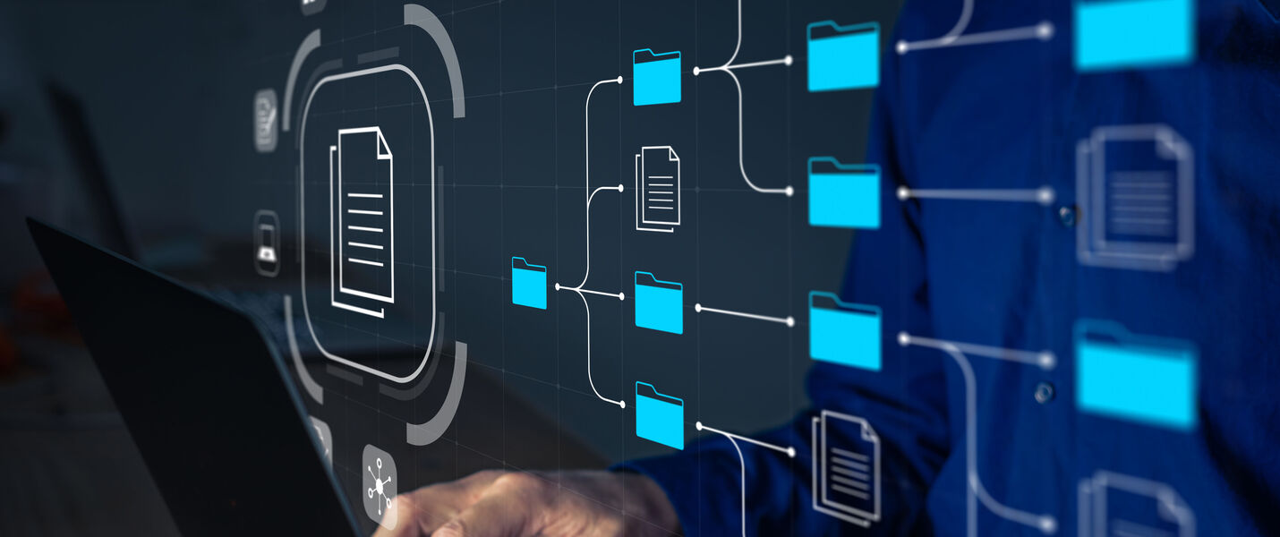Person typing on a laptop with a holographic network of blue folders and documents connected by lines, illustrating digital file management and cloud storage.