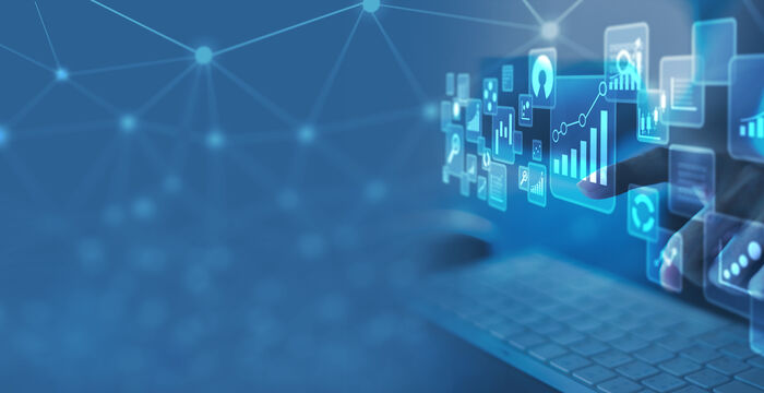 Blue-toned digital scene with a laptop and floating holographic icons of charts and graphs, illustrating data analytics and connectivity.